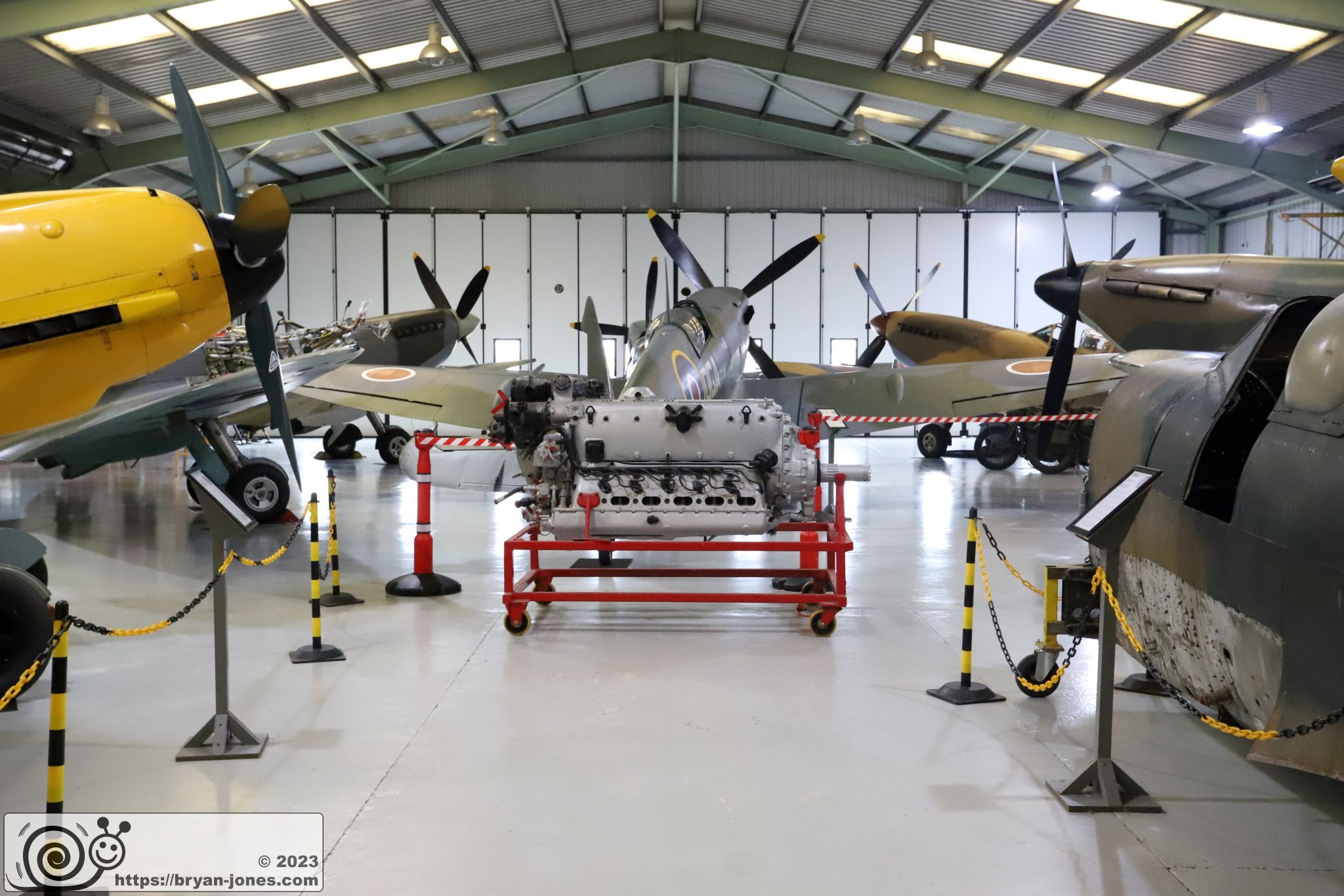 Spitfires, Hurricane and Messerschmitt Bf 109 E1 in the hangar