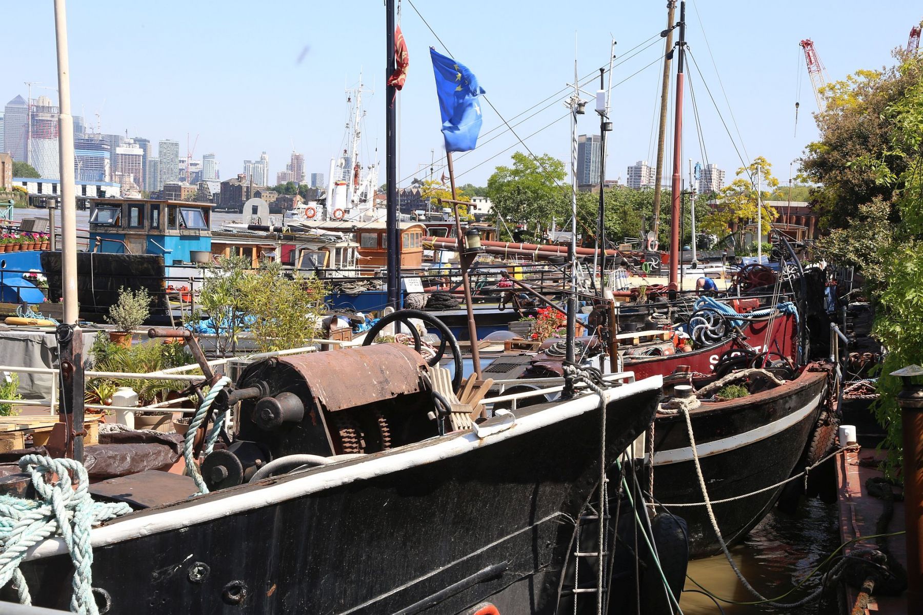 Houseboats and gardens at Tower Bridge moorings on the River Thames in London. Taken on 19-May-2018 during London Open Gardens Weekend. House boat.