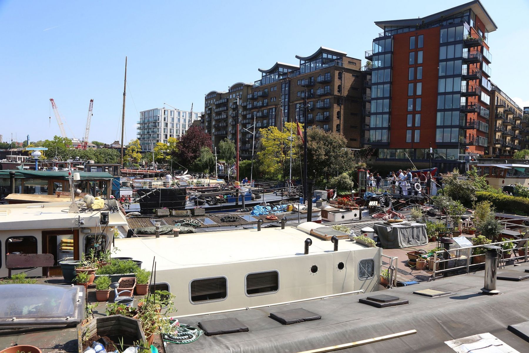 Houseboats and gardens at Tower Bridge moorings on the River Thames in London. Taken on 19-May-2018 during London Open Gardens Weekend. House boat.