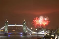 Tower Bridge with 2019 fireworks at Southwark Park as a dramatic backdrop